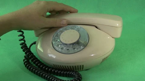Hand with a wedding ring dials a number on a dial-up telephone Stock Footage 31748288