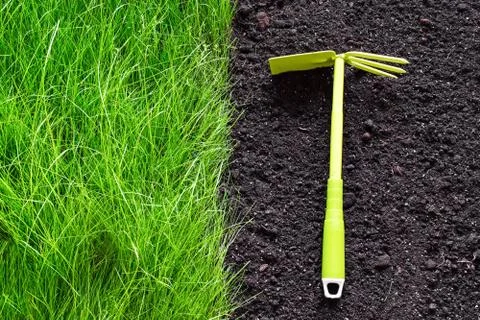 Hand weeding grass with garden tools. Clear field Stock Photos