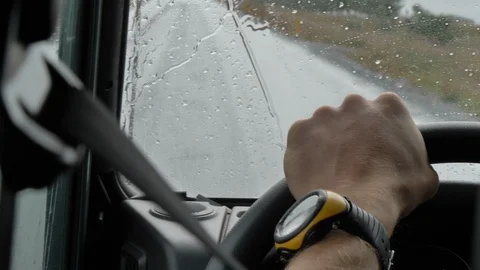 Hand on the wheel while driving with rain Stock Footage 124078078