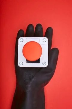 The hand which keep the emergency button at the red b.. Stock Photos