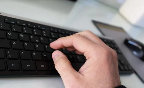 Hand which type on the black keyboard Stock Photos