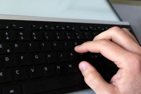 Hand which type on the black keyboard Stock Photos