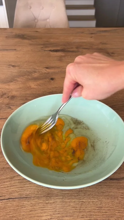 Hand Whisking Raw Eggs with Fork in Bowl on Table 4K⁠ Stock-Footage 346912278