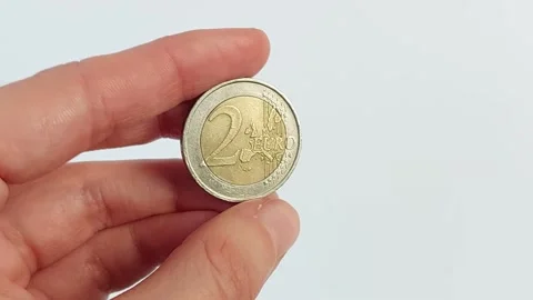 A hand on a white background holds a two euro coin. Stock Footage 168125316