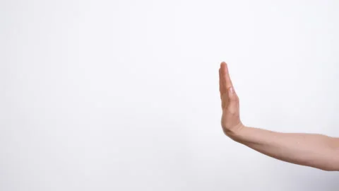 A hand on a white background pushes out text or advertising. Copy space. Stock Footage 230528117