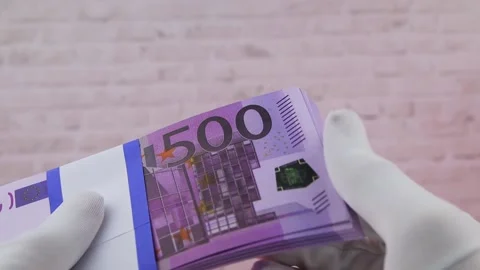 A hand in a white glove holds a stack of 500 euro paper bills, Close-up, FullHD Vídeo Stock 141450917