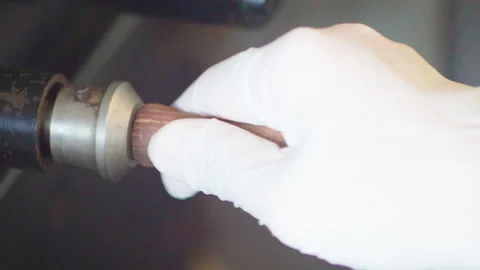 Hand white glove pulling roast coffee beans example from roaster machine Stock-Footage 156251058