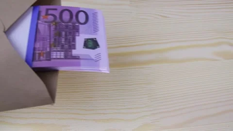 Hand in a white glove puts an envelope with a pack of 500 euro bills on a table 스톡 동영상 145465927