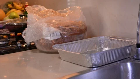 Hand in white gloves puts pieces of marinated chicken on the grill 動画素材 81667457