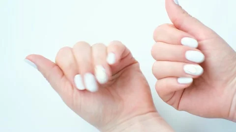 Hand with white manicure on white background, top view. Stock Footage 238967172