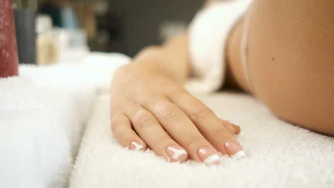 Hand on a white towel model lying in a spa. Manicure Stock Footage 139914406