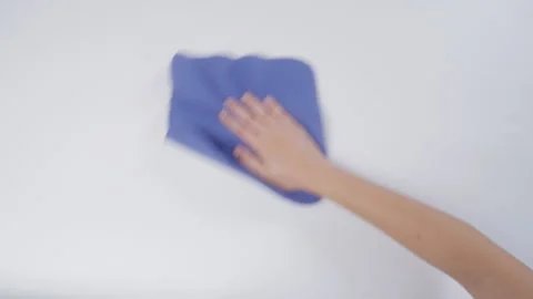 Hand wipe white table with blue rug Stock Footage 242829928
