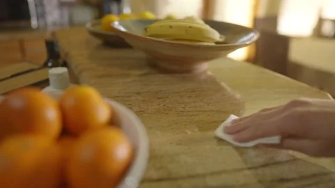 Hand wipes down dirty marble countertop with cloth and rubbing alcohol, Stock Footage 142033327