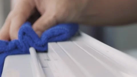 Hand wiping dust by blue microfiber cloth for cleaning. Video stock 160030346