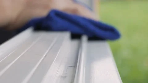 Hand wiping dust by blue microfiber cloth for cleaning. Stock Footage 165682367