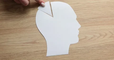 Hand of woman puts missing piece paper of human head shape Stock Footage 239999891