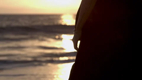 Hand of Woman Resting by Side While Standing at Ocean During Sunset Stock Footage 270297381
