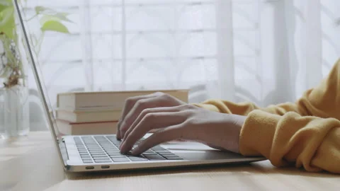 Hand of woman using laptop computer to work, typing at home Stock Footage 144796419