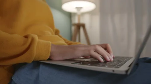 Hand of woman using a laptop computer to work, typing at home Stock Footage 145740607