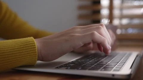 Hand of woman using a laptop computer to work, typing at home Stock Footage 149118500