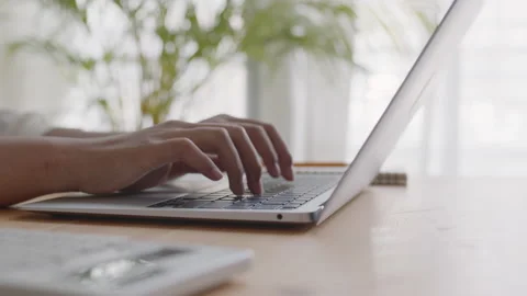 Hand of woman using a laptop computer, typing work at home Stock Footage 151808079