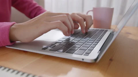 Hand of woman using a laptop computer, typing work at home Stock Footage 156183111