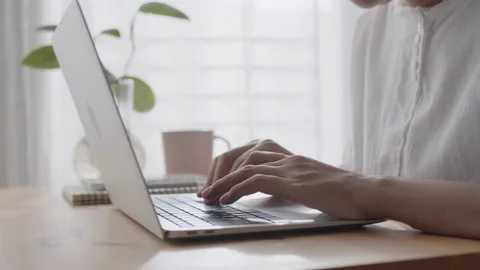 Hand of woman using a laptop computer, typing work sunlight morning at home Stock Footage 159944573
