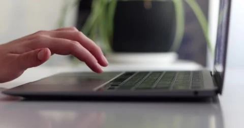 Hand of woman using laptop computer to work, typing at home and scrolling, wh Stock Footage 300364074