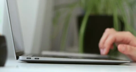 Hand of woman using laptop computer to work, typing at home and scrolling, wh Stock Footage 300364146