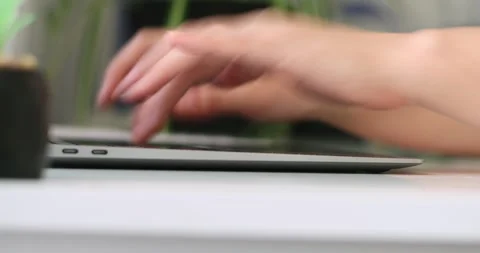 Hand of woman using laptop computer to work, typing at home and scrolling, wh 库存影片 300364153