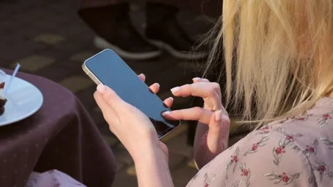 Hand of a woman using a mobile phone reads a phone message and browses the news Stock Footage 278869204