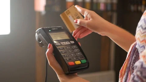 Hand of woman using payment terminal in an electrical shop, paying with credit Video stock 99090827