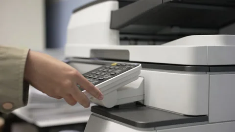 Hand of woman is using a photocopier to copy documents. Stock Footage