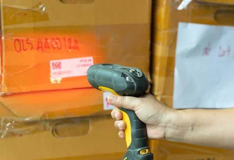 Hand of woman using wireless barcode reader, reads information from a QR code. Stock Photos