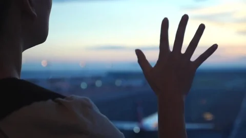 Hand Of Woman On Window At Airport Against Airplane At Sunset Stock Footage