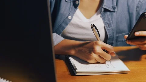 Hand of women write a notebook at night time, Small business Stock Footage 114199765