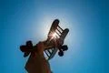 The hand with a wood plane on the background of the bright sun Photo