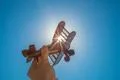 The hand with a wood plane on the background of the bright sun Photo