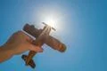 The hand with a wood plane on the background of the sun Photo