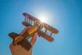 The hand with a wood plane on the background of the sun Photo