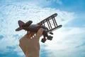 The hand with a wooden plane on the blue sky background Photo