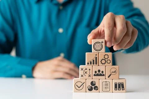 Hand woods block cube with icon company strategy development, Concept succe.. Stock Photos