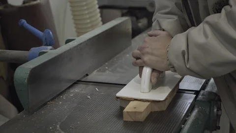 Hand of woodworker using sander machine for sanding chopping boards, close up. Stock Footage 88100004