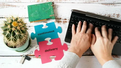 Hand work at computer near puzzle with word continuous delivery and motherboard. Stock Footage 122418322