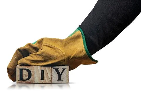 Hand with Work Gloves Holding Text Diy made of Wooden Blocks Stock Photos