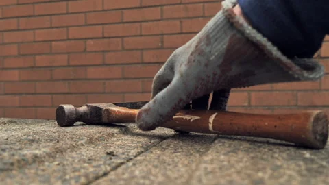 Hand in work gloves lifts a hammer Stock Footage 346766902