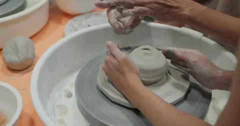 Hand work on pottery wheel, shaping a clay pot Stock Footage 137460607