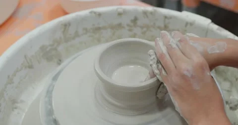 Hand work on pottery wheel, shaping a clay pot, student make of clay pot at s Stock Footage 138397573
