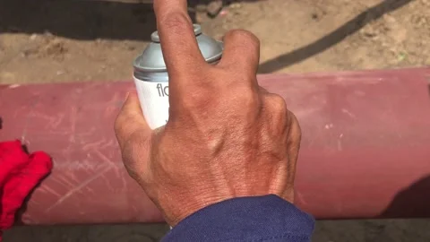 Hand of worker doing Dye Penetrant Inspection of the mild steel pipe. Video stock 157283871