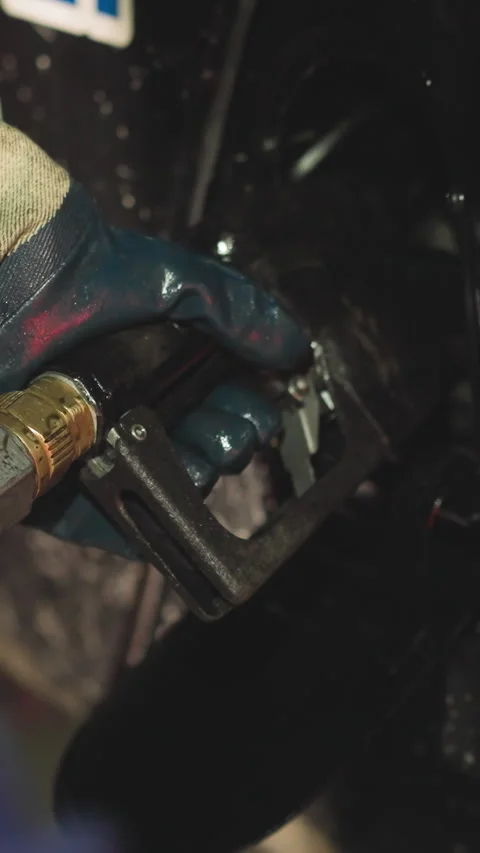 Hand of worker inserting fuel gun to fill vehicle with fuel Stock Footage 309049912